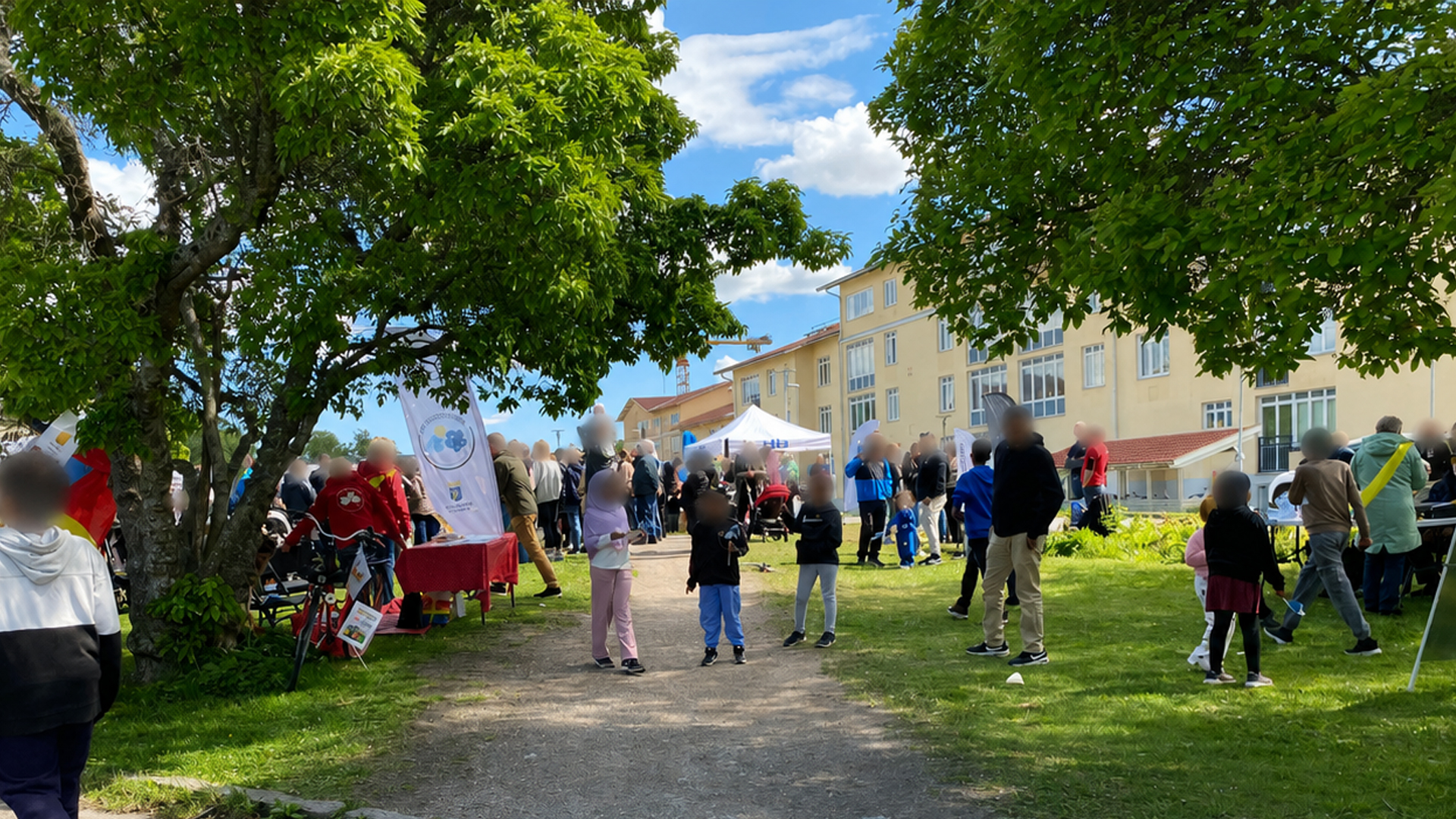 Folksamling på en gräsyta med eventtält